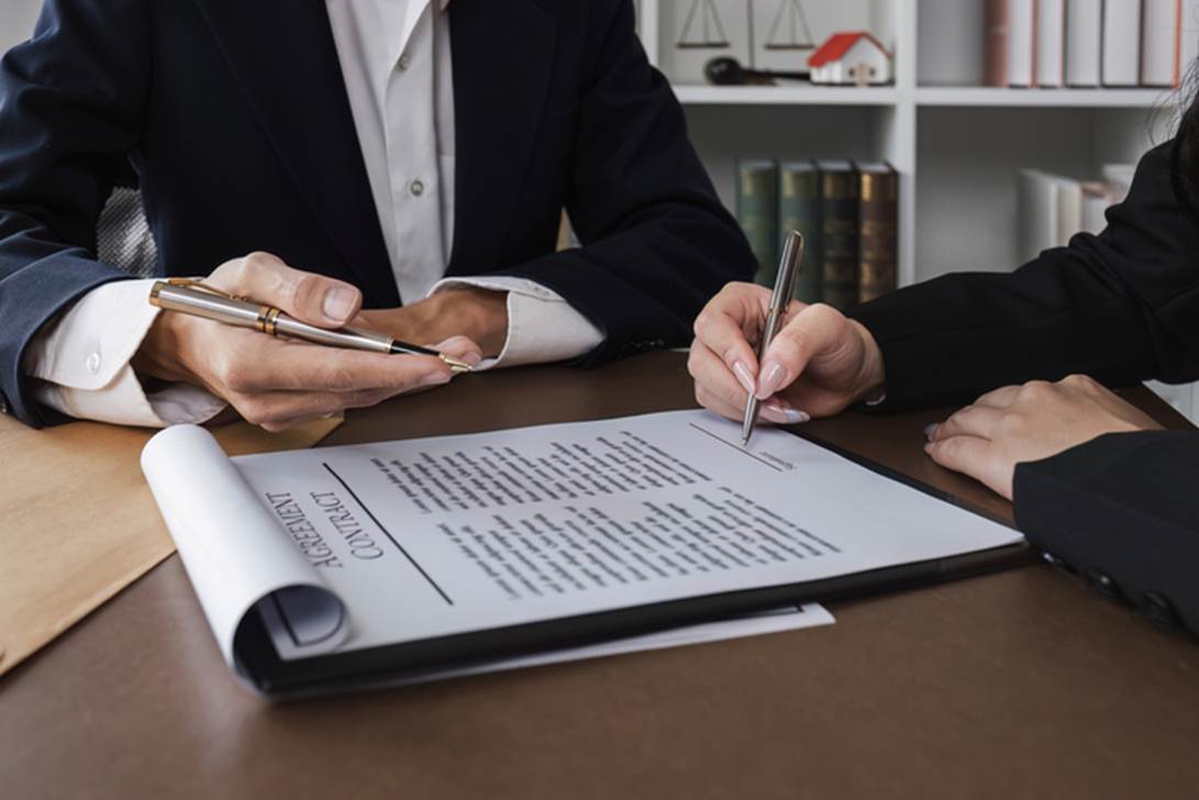 A close-up of people signing a document

AI-generated content may be incorrect.